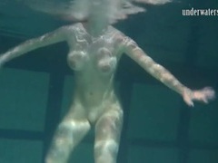 UhPorn presents: Naked brunette with big tits swims solo