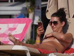 UhPorn presents: Topless amateur relaxes on a lounge chair